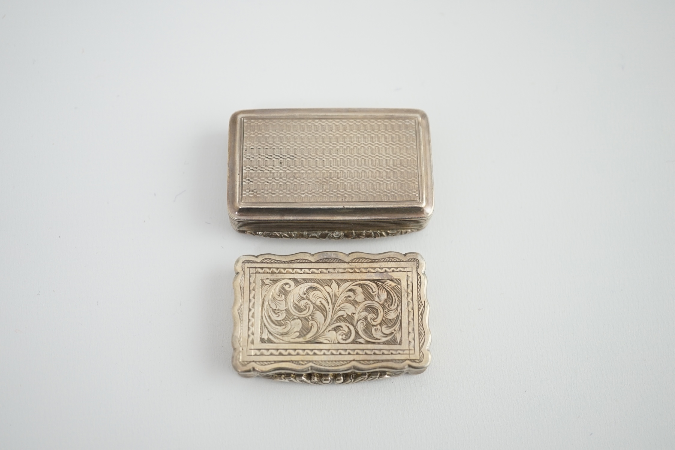 A George IV silver snuff box, with engraved initials, Thomas Shaw?, Birmingham, 1826, 54mm, together with a Victorian silver snuff box, George Unite, Birmingham, 1875.